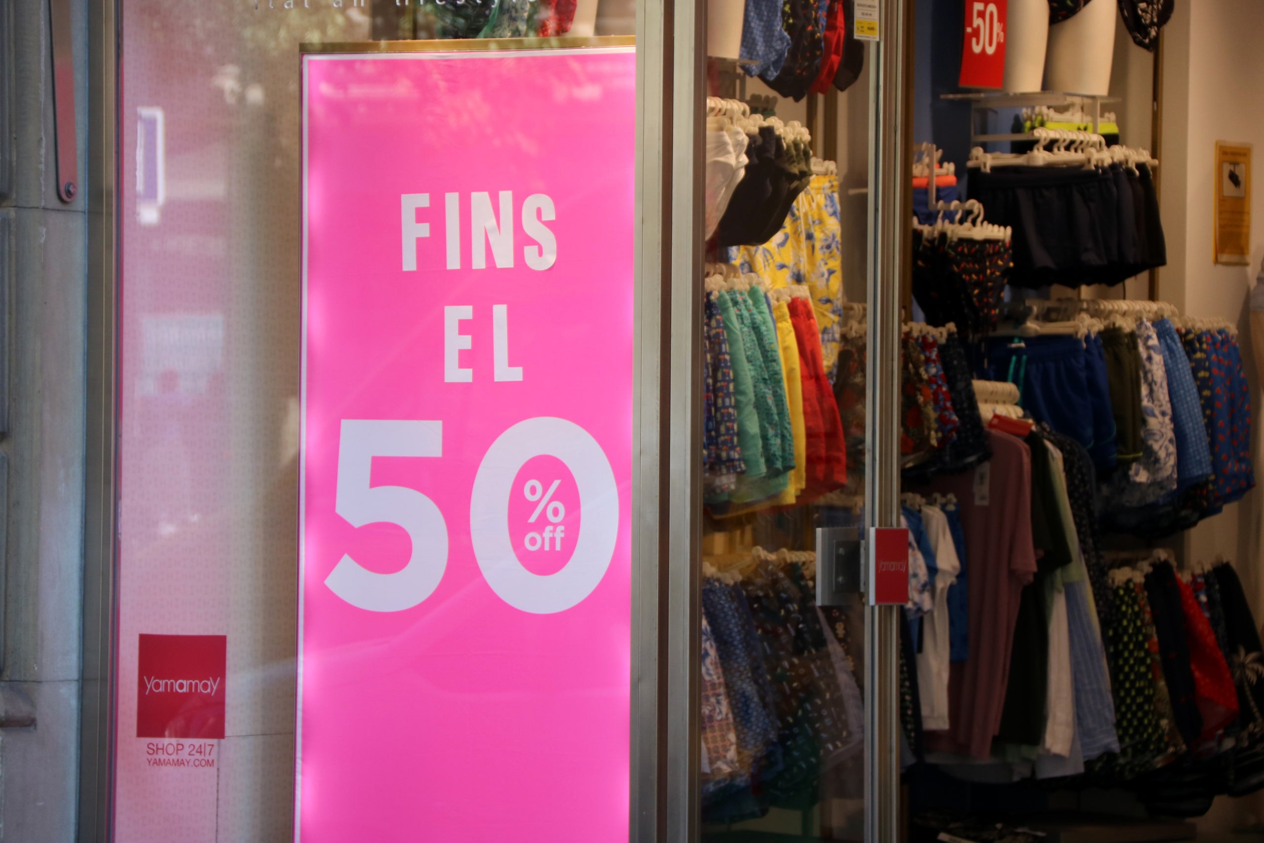 Un cartell que anuncia descomptes fins al 50% en un aparador | Maria Asmarat (ACN)